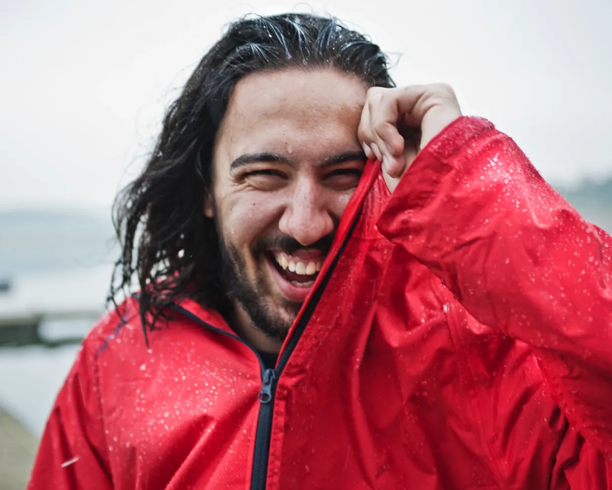 ielts-student-smiling-man-red-jacket