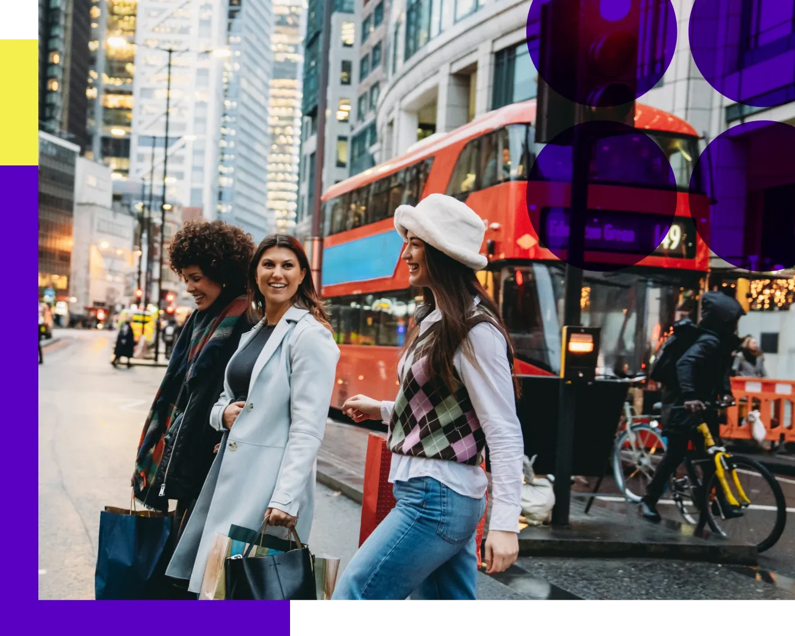 Group of girlfriends crossing the street in front of red London bus
