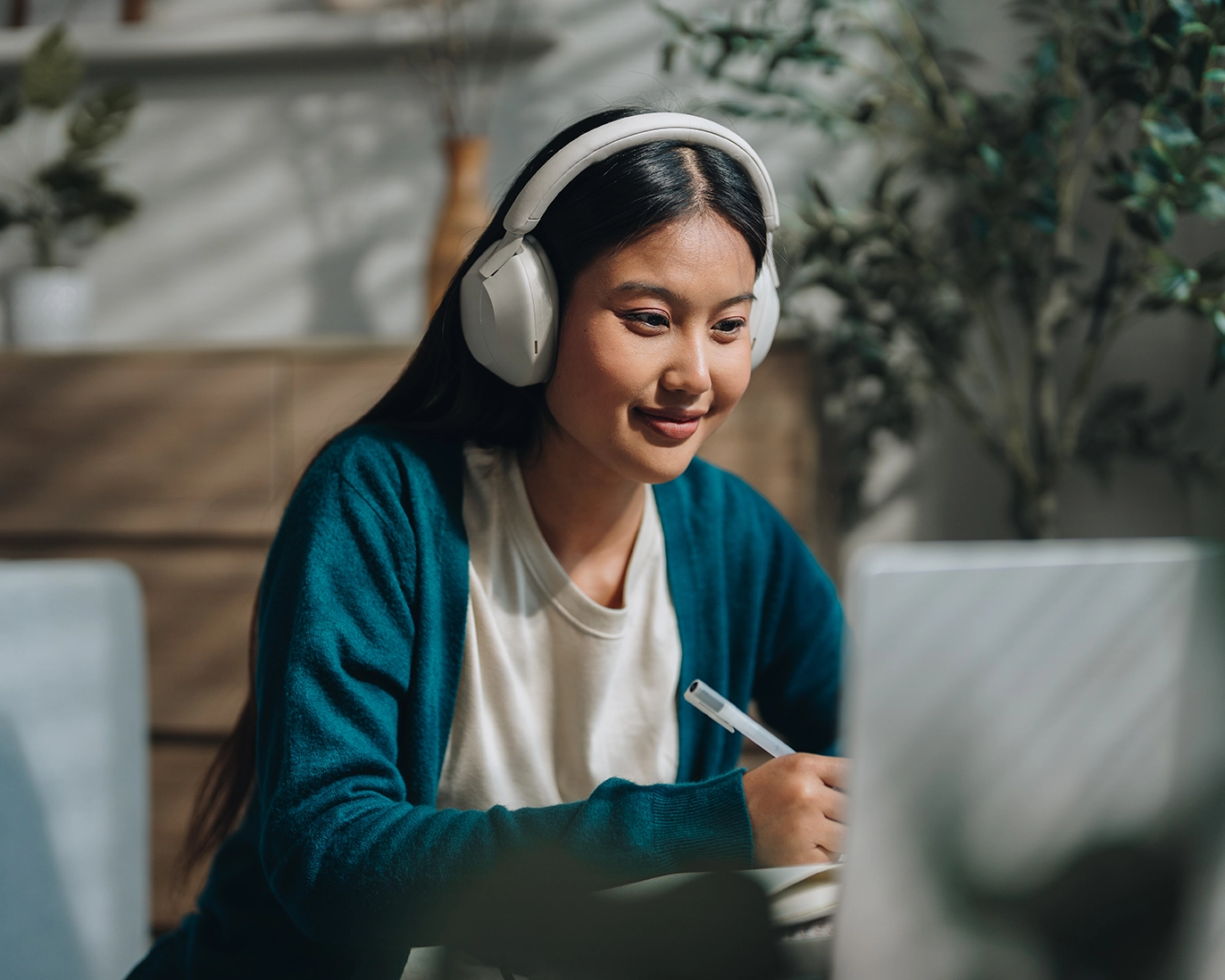 girl-studying-for-ielts-with-headphones-and-laptop