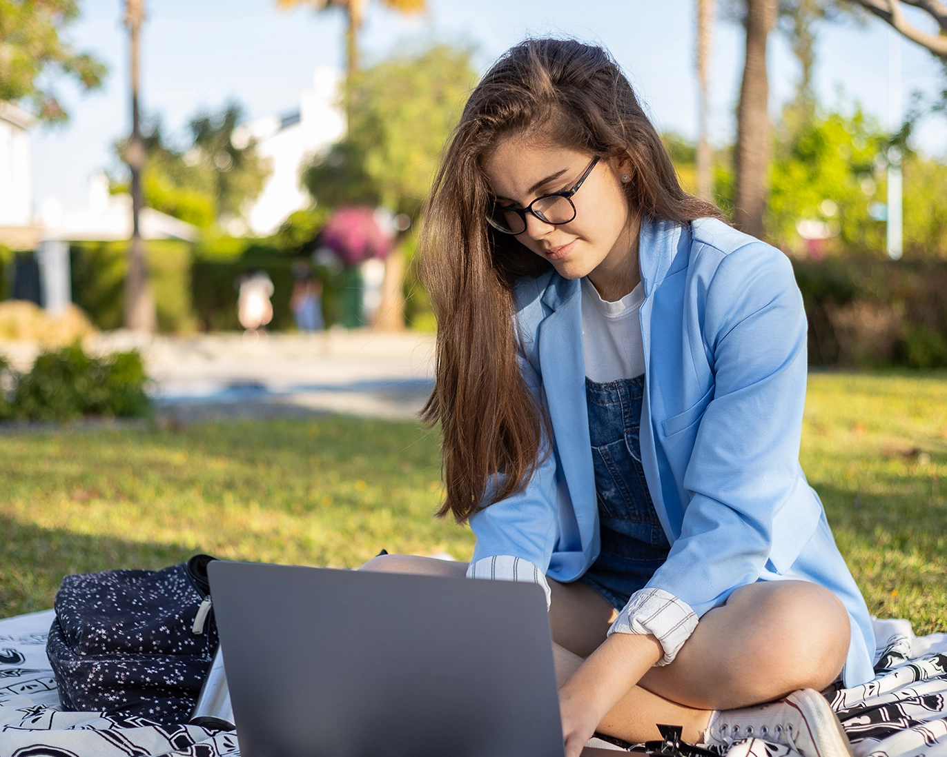 young-woman-online-ielts-study-outdoors
