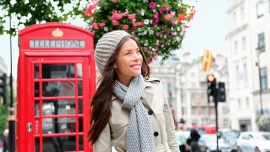 young woman in front of a red telephone box