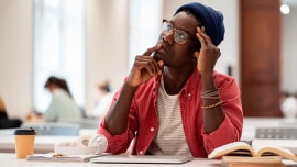 young man sitting over some papers and thinking
