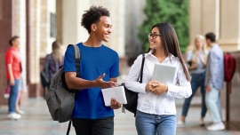 A man and a woman talk while they walk