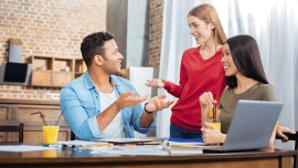 Students have a conversation and smile 