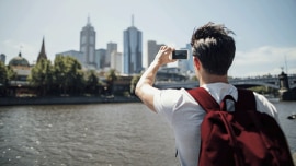 A guy takes picture od a river view in Australia