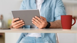 Close up of a man holding his tablet