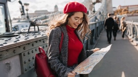 A girl studies the map while exploring a new city