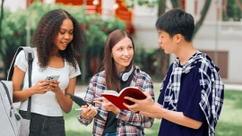 Students talking while looking at books and phones