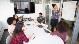 a classroom of students being taught by the whiteboard