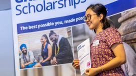 Student showcasing her Great Scholarship certificate with pride