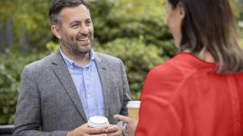 Professionals talking while having coffee