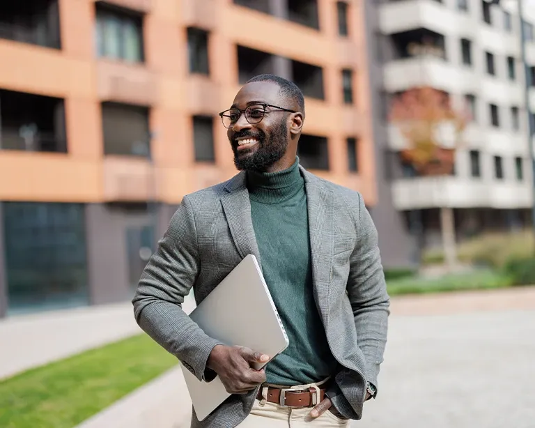 Young man walking outdoors in a modern city during his work abroad journey