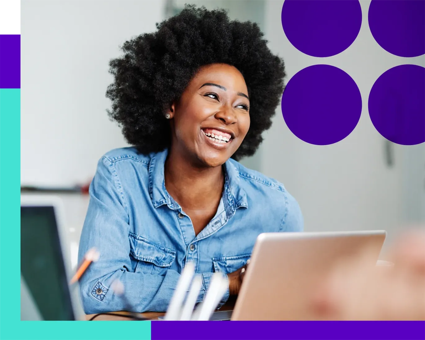 Young woman smiling while working on a laptop during a study session.