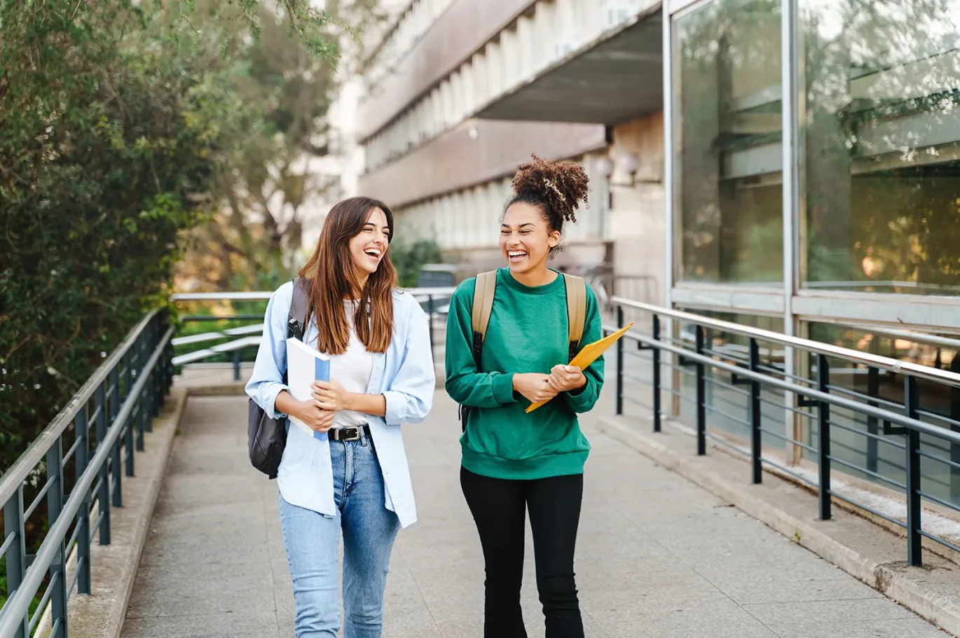 Two females smiling and discussing after giving their IELTS exam