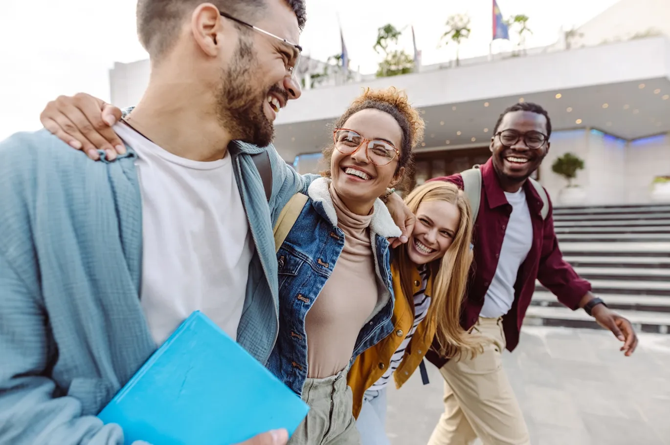 Group of friends celebrating success after giving IELTS test
