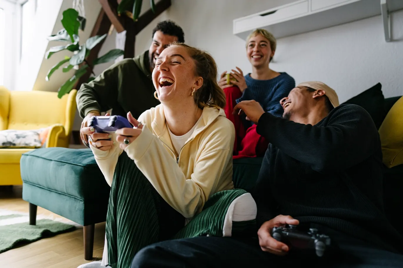 Friends relaxing together indoors while playing video games.