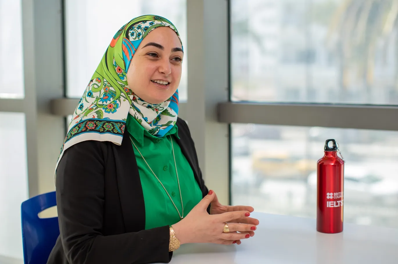 Woman discussing IELTS-related information during a counseling session indoors.