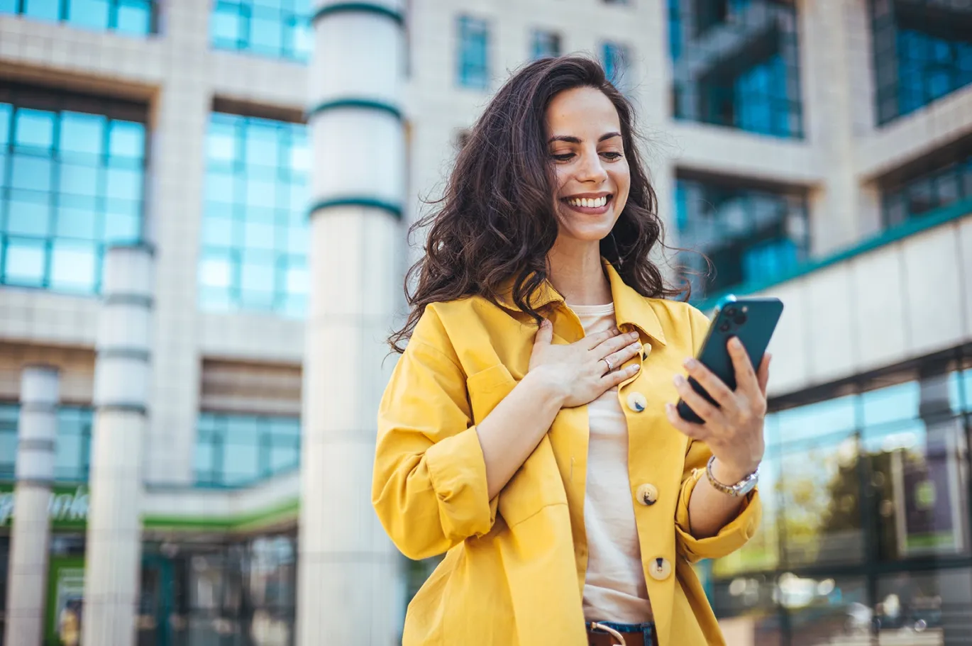 Young woman smiling while preparing for the IELTS exam outdoors.