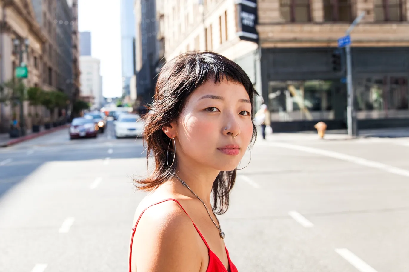 Young woman standing on a quiet European city street.