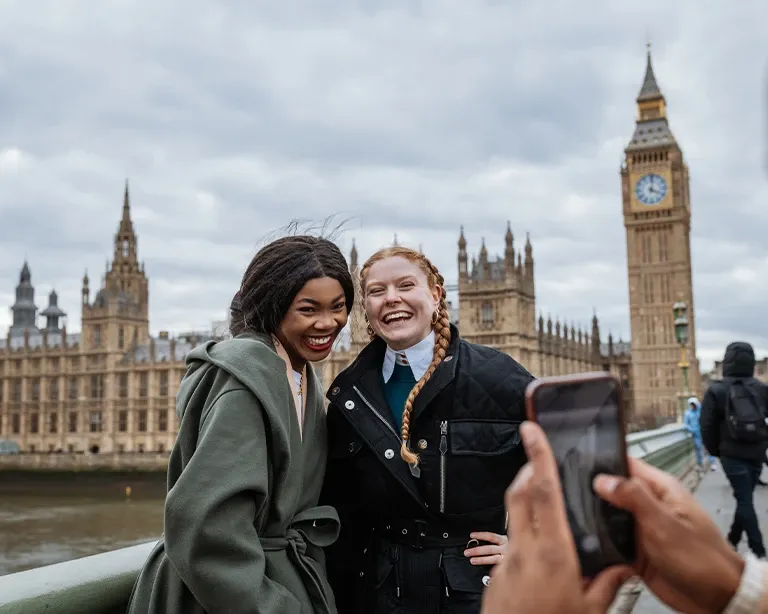 Girls posing infront of Big Ben in London after giving IELTS exam