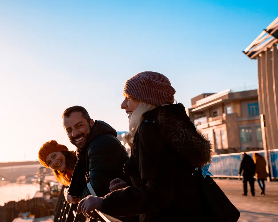 Group of friends enjoying a scenic view standing on bridge
