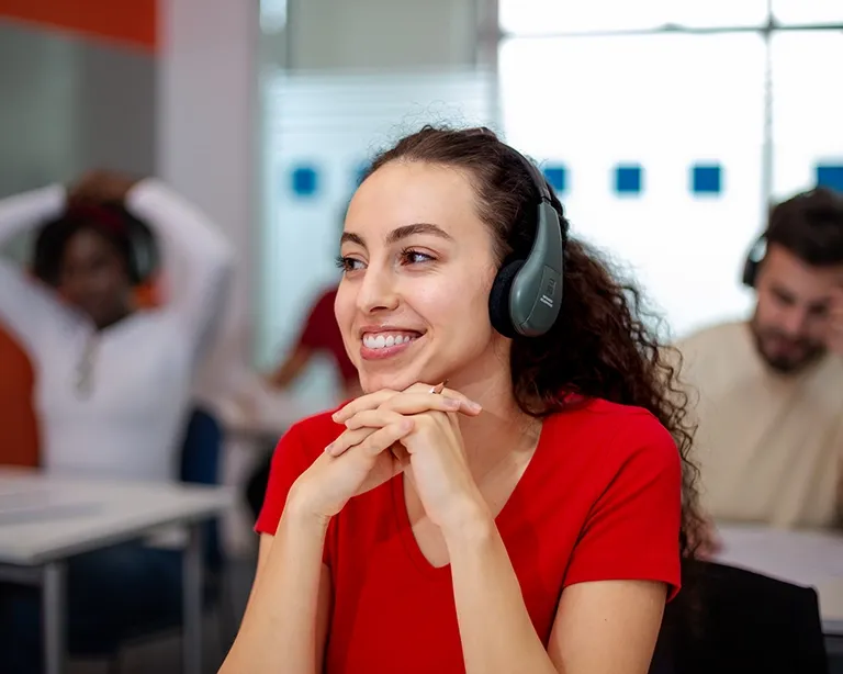 Girl smiling and  taking the IELTS One Skill Retake test