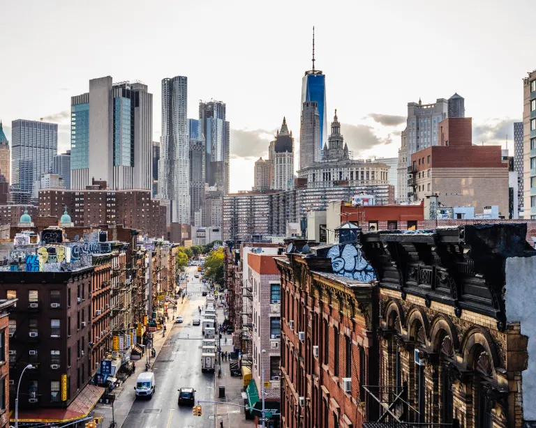 City skyline with high-rise buildings and a busy urban street.