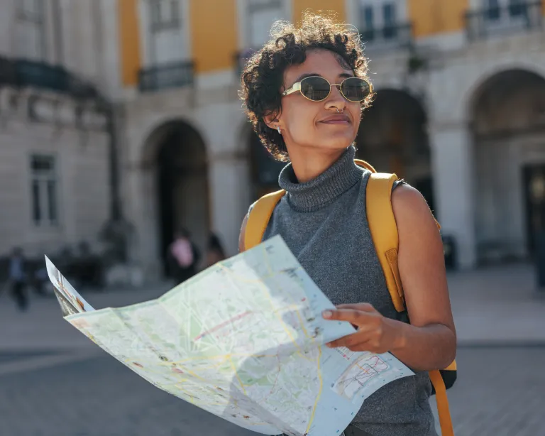 A girl exploring city streets using a roadmap.