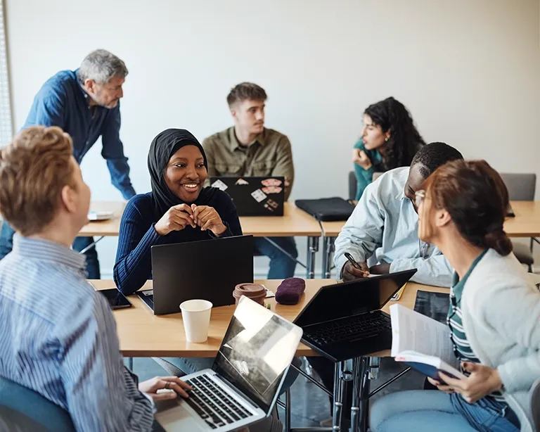 Group of students discussing IELTS preparation together during a study session.