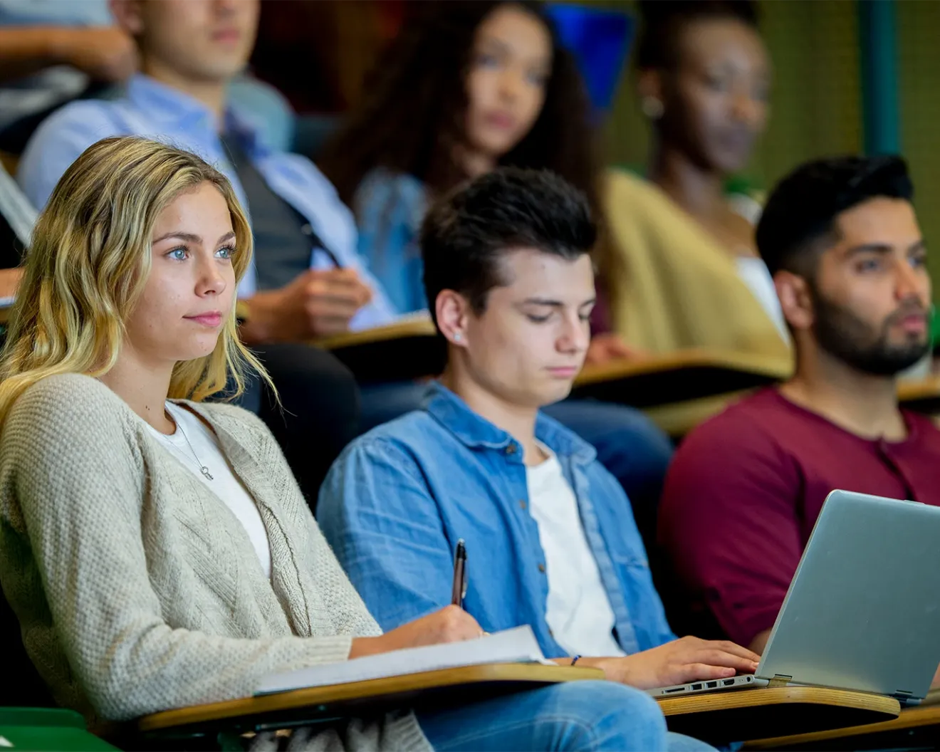 IELTS test takers attending a classroom session with laptops during exam preparation training