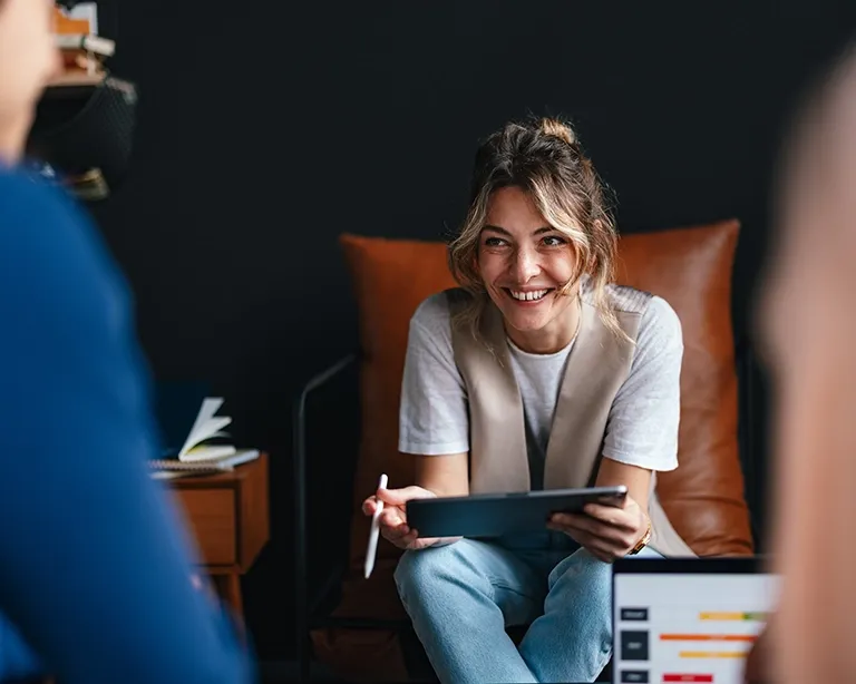 Young woman discussing IELTS preparation during a study session.