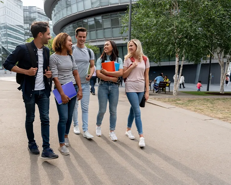 Group of students walking together outdoors near an IELTS campus area.