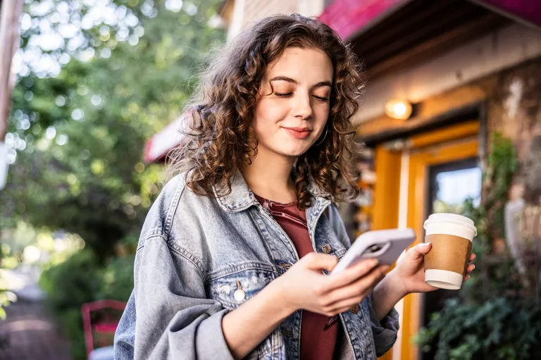 Young woman practicing English speaking skills while studying at a cafe.