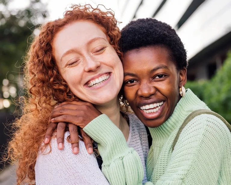 two-friends-hugging-outdoors.jpg