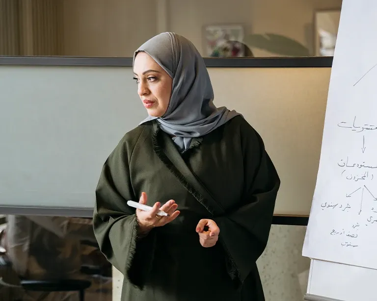 Woman giving guidance during an IELTS counseling or classroom session.