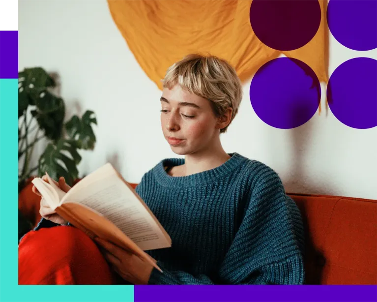 Young woman studying from notes while preparing for the IELTS exam at home.