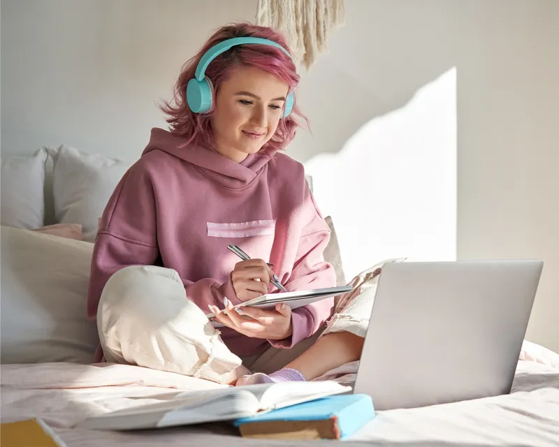 girl-taking-notes-studying-ielts-exam-online