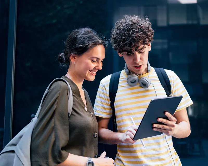 two-students-looking-tablet