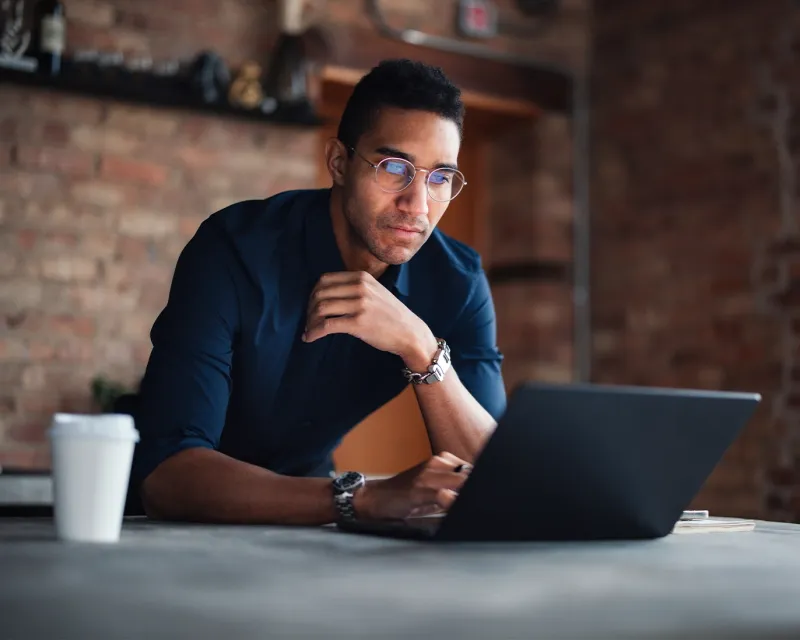 young-man-online-ielts-study-laptop-cafe