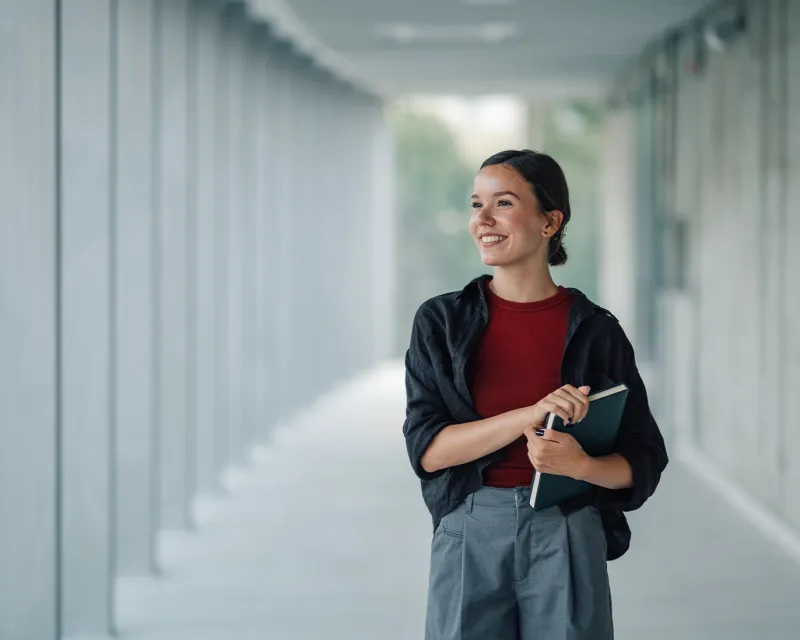 young-woman-ielts-study-materials-modern-hallway